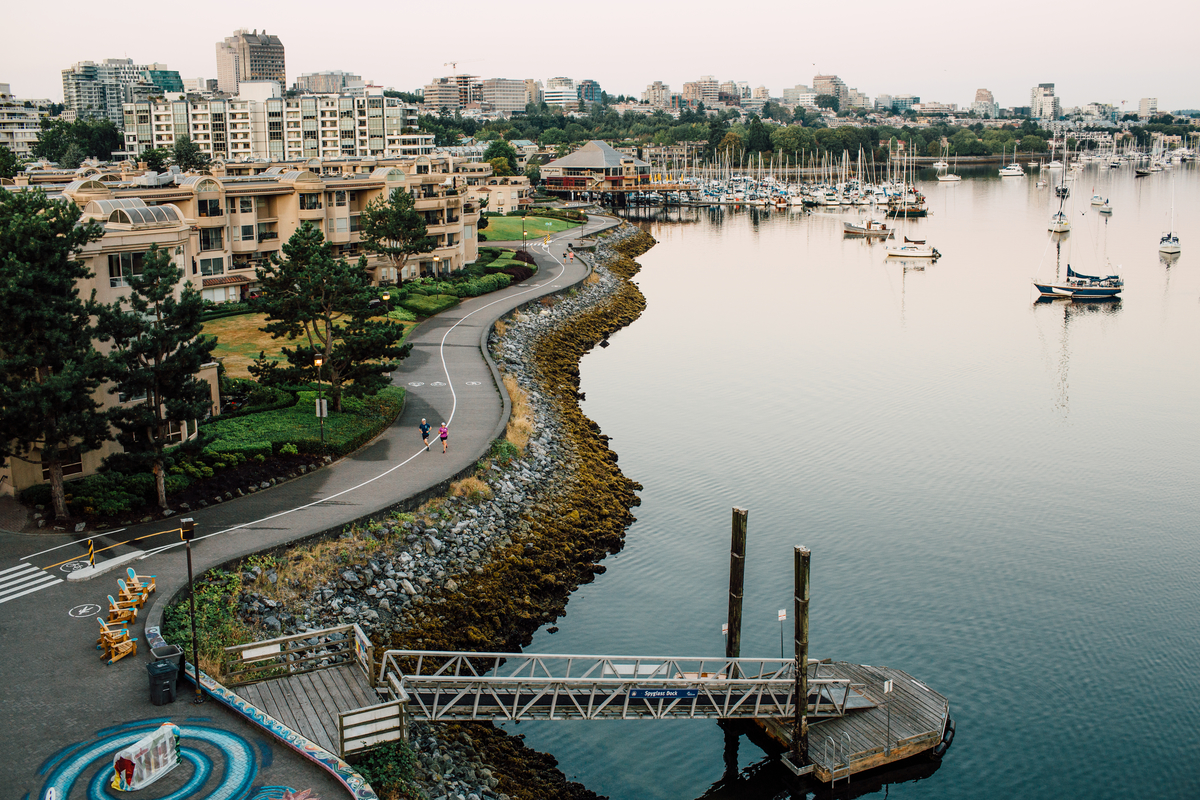 Pedestrians on the False Creek seawall loop, from Cambie Street Bridge in Vancouver