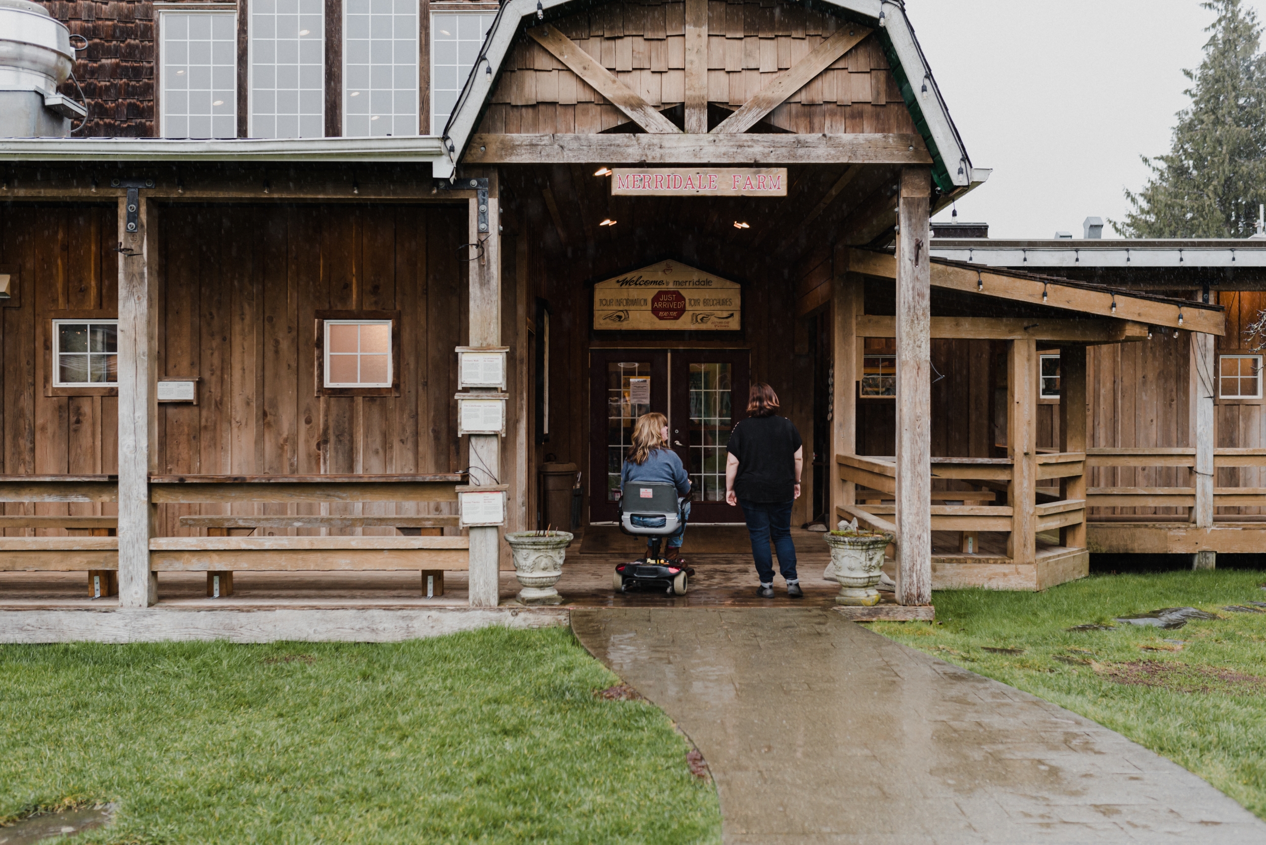 Two people, one in a wheelchair, entering Merridale Cidery & Distillery | Lexa Bergen